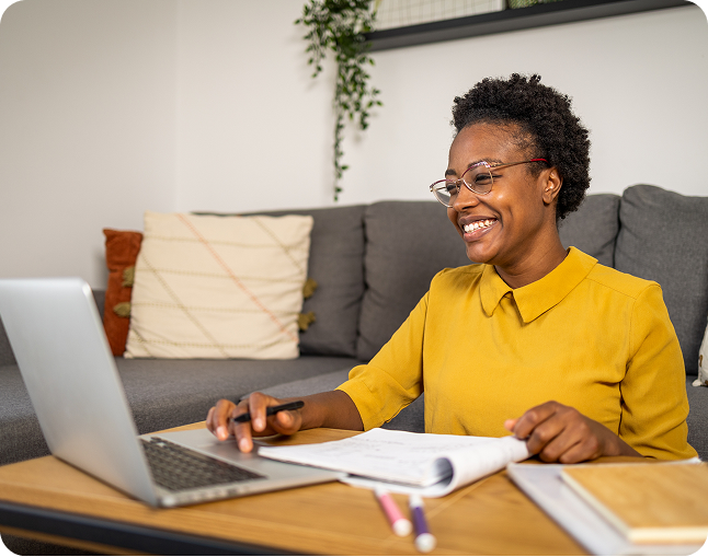 Smiling woman working on laptop at home.