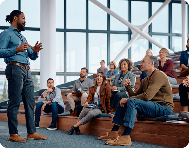 People attending a presentation in modern auditorium.
