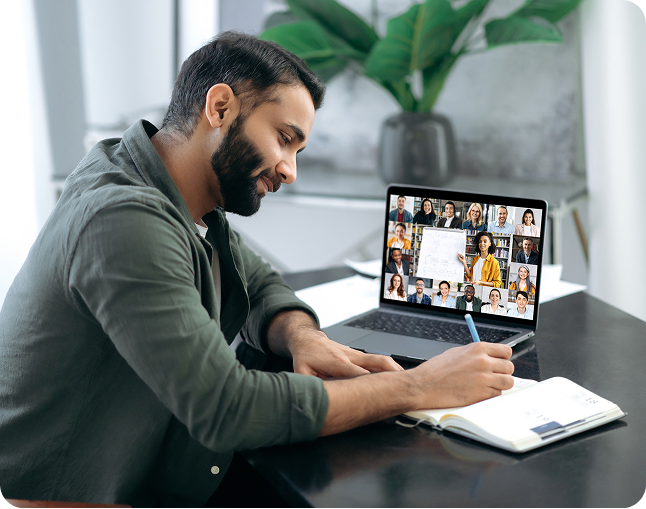 Man taking notes during a video call.